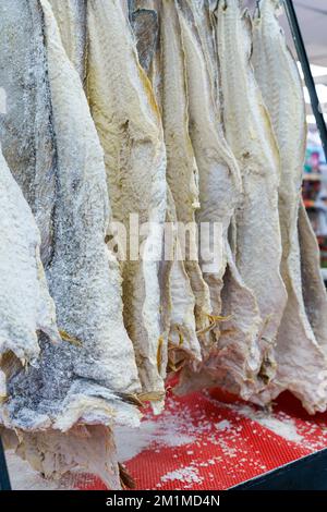 Salted dried cod bacalao on the counter of a fish store. Traditional Portuguese and Scandinavian sea fish dish. High quality photo Stock Photo