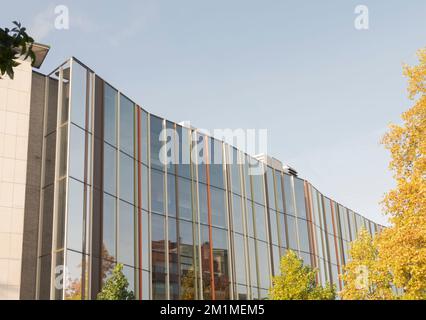Hasselt, Limburg-Belgium. 23-10-2021. Building with reflective glass on the front. Against the background of the blue autumn sky Stock Photo