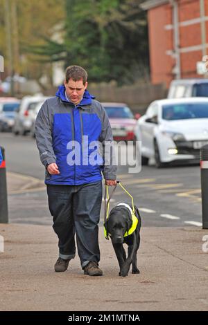 Guide dog and owner, walking through a town Stock Photo