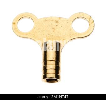 A simple brass metal radiator valve key. A plumbers standard tool in their toolkit. Used to vent trapped air in a central heating system. Stock Photo