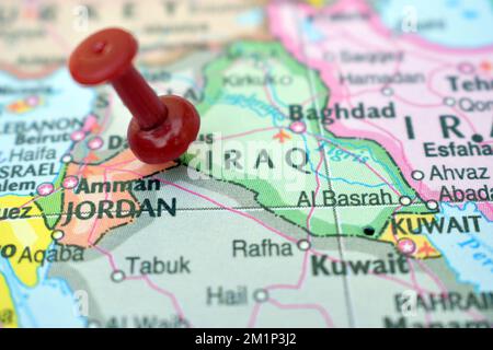 Red Push Pin Pointing on Location of Iraq World Map Close-Up View Stock Photograph Stock Photo