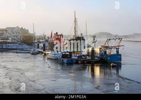 Irvine, UK. 12th Dec, 2022. With temperatures as low as minus 15C in parts of Scotland, freezing fog and the unusually cold winter weather has caused Irvine harbour on the Firth of Clyde to freeze over, trapping several boats and small ships. Credit: Findlay/Alamy Live News Stock Photo