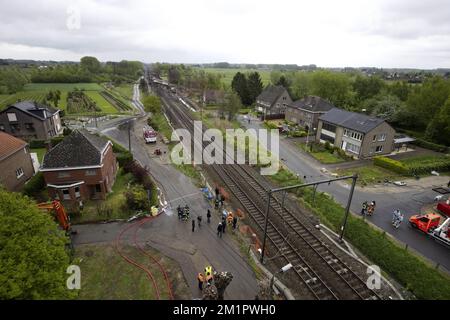 Illustration picture shows the the wrecked train from a ladder of fire brigade  in Wetteren, Saturday 11 May 2013. In the night from Friday 3 to Saturday 4 May a freight train derailed and exploded on a track near Schellebelle (part of Wichelen, Wetteren). The train contained the chemical product acrylonitrile, a toxic and inflammable fluid that can cause breathing problems. Emergency services evacuated some 2000 residents. One local resident died and in a week, 397 persons were brought to hospital, for intoxication and control. BELGA PHOTO POOL NICOLAS MAETERLINCK Stock Photo