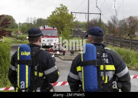 Illustration picture shows firemen in Wetteren, Saturday 11 May 2013. In the night from Friday 3 to Saturday 4 May a freight train derailed and exploded on a track near Schellebelle (part of Wichelen, Wetteren). The train contained the chemical product acrylonitrile, a toxic and inflammable fluid that can cause breathing problems. Emergency services evacuated some 2000 residents. One local resident died and in a week, 397 persons were brought to hospital, for intoxication and control.  Stock Photo