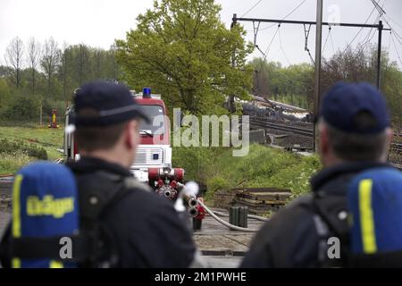 Illustration picture shows firemen in Wetteren, Saturday 11 May 2013. In the night from Friday 3 to Saturday 4 May a freight train derailed and exploded on a track near Schellebelle (part of Wichelen, Wetteren). The train contained the chemical product acrylonitrile, a toxic and inflammable fluid that can cause breathing problems. Emergency services evacuated some 2000 residents. One local resident died and in a week, 397 persons were brought to hospital, for intoxication and control.  Stock Photo