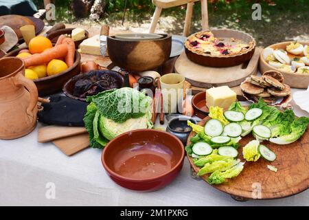 Table of vegetables and traditional food at a Medieval re-enactment event Stock Photo