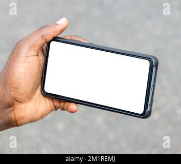 black african hand holding and using blank screen mobile phone horizontally Stock Photo