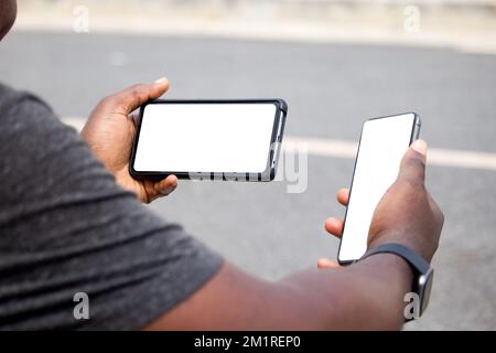 black african hand holding and using blank screen mobile phone horizontally Stock Photo