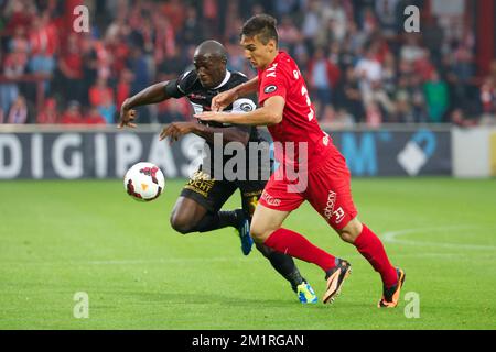 Mechelen's Benjamin Mokulu and Kortrijk's Zarko Tomasevic fight for the ball during the Jupiler Pro League match between KV Kortrijk and KV Mechelen, in Kortrijk, Saturday 24 August 2013, on day 5 of the Belgian soccer championship.  Stock Photo