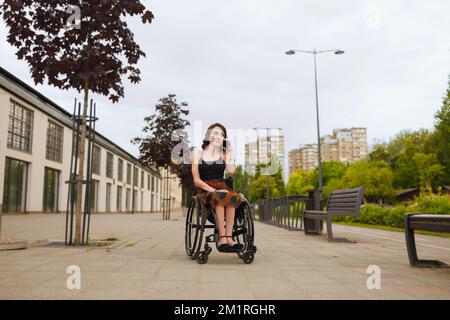 Young woman i wheelchairs calling her friends Stock Photo
