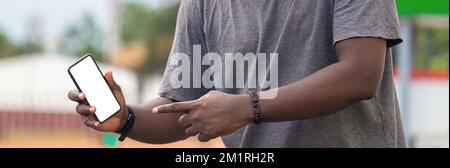 Hand of young black african man holding white blank screen smartphone Stock Photo