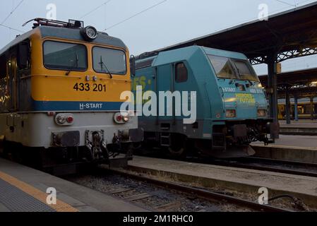 MAV Hungarian State Railways electric Class V43 locomotive with a private owner Vectron locomotive at Keleti Station, Budapest, Hungary Stock Photo