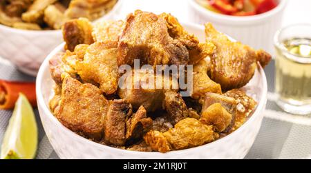 Crackling bowl, Brazilian appetizer made by frying bacon, leather or meat and lots of fat Stock Photo