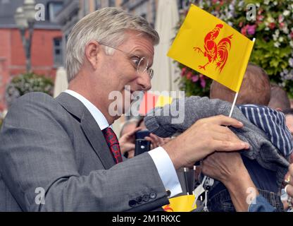 King Philippe - Filip of Belgium is handed a flag of Wallonia as he greets the public during the 'Joyous Entry-Blijde Intrede-Joyeuse Entree' of King Filip and Queen Mathilde to present themselves to the public in the different provincial capitals, in Mons, Hainaut province, Tuesday 17 September 2013. BELGA PHOTO ERIC LALMAND Stock Photo