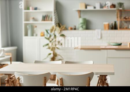 Background image of cozy kitchen interior with dining table set in minimal white tones, copy space Stock Photo
