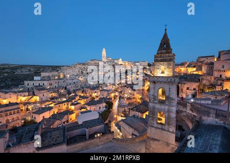 View over the Sassi di Matera old town with the campanile of the church of Saint Peter Barisano floodlit at night, Matera, Basilicata, Italy, Europe Stock Photo
