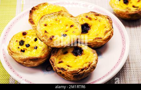 Portuguese Pastel de Nata, called Pastel de Belem, traditional Portuguese delicacy made with eggs, cinnamon and caramel, typical sweet made with eggs Stock Photo