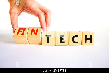 Tech or fintech symbol. Concept word Tech and Fintech on wooden cubes. Businessman hand. Beautiful white table white background. Business and tech or Stock Photo