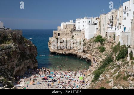 View of  beach and old town on limestone cliffs seen from Ponte Borbonico su Lama Monachile bridge, Polignano a Mare, Puglia, Italy, Europe Stock Photo