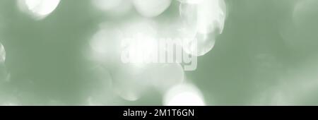 Blurred lights, green background, banner texture. Abstract bokeh with soft light header. Wide screen wallpaper. Panoramic web banner with copy space f Stock Photo