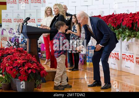 Arlington, United States. 12th Dec, 2022. U.S. President Joe Biden congratulates a young boy after he read a poem during a Marine Corps Reserve sorting event for Toys for Tots with First Lady Jill Biden at Joint Base Myer-Henderson Hall, December 12, 2022 in Arlington, Virginia. Credit: Adam Schultz/White House Photo/Alamy Live News Stock Photo