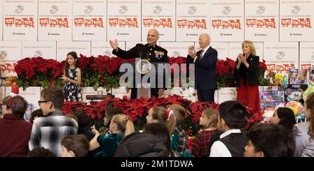 Arlington, United States. 12th Dec, 2022. U.S. Marine Corps Reserve General David Bellon, center, welcomes President Joe Biden and First Lady Jill Biden, right, to the 75th anniversary Toys for Tots sorting at Joint Base Myer-Henderson Hall, December 12, 2022 in Arlington, Virginia. Credit: Adam Schultz/White House Photo/Alamy Live News Stock Photo