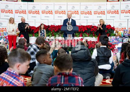 Arlington, United States. 12th Dec, 2022. U.S. President Joe Biden delivers remarks to military families during a Marine Corps Reserve sorting event for Toys for Tots with First Lady Jill Biden, right, at Joint Base Myer-Henderson Hall, December 12, 2022 in Arlington, Virginia. Credit: Adam Schultz/White House Photo/Alamy Live News Stock Photo