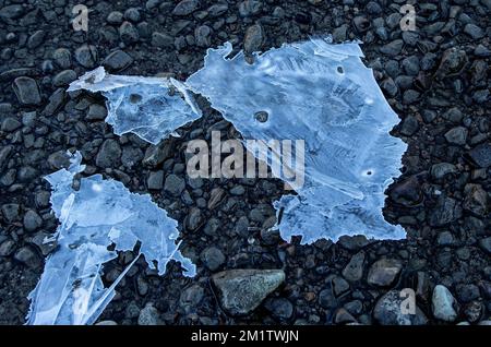 Dry ice on pebbles at the side of a lake. Stock Photo