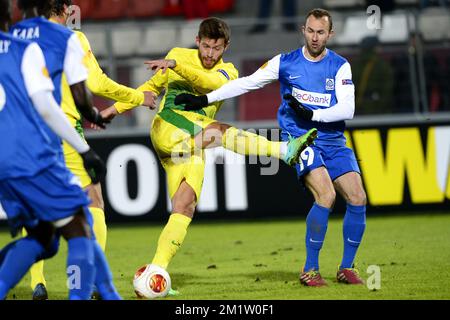 20140220 - MOSCOW, RUSSIA: Anzhi's Fedor Smolov and Genk's Thomas Buffel fight for the ball during a soccer match between Belgian first division soccer team KRC Genk and FC Anzhi Makhachkala from Dagestan, Subject of Russia in Moscow, Russia, Thursday 20 February 2014, in the 16th finals of the Europa League tournament. BELGA PHOTO YORICK JANSENS Stock Photo