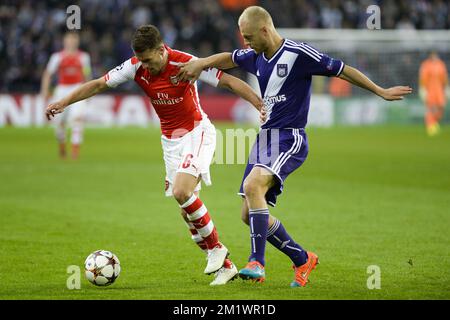 Arsenal's Aaron Ramsey and Anderlecht's Olivier Deschacht fight for the ball during a third group stage game between RSCA Anderlecht and English team Arsenal, in the group D of the UEFA Champions League competition, Wednesday 22 October 2014. BELGA PHOTO LAURIE DIEFFEMBACQ Stock Photo