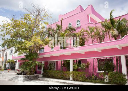 The bright pink color residential house on a main street in San Miguel resort town on Cozumel island (Mexico). Stock Photo