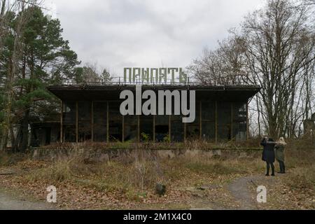 Portuary coffe building with autum forest and tourist at chernobyl radioactive disaster exclusion zone Stock Photo