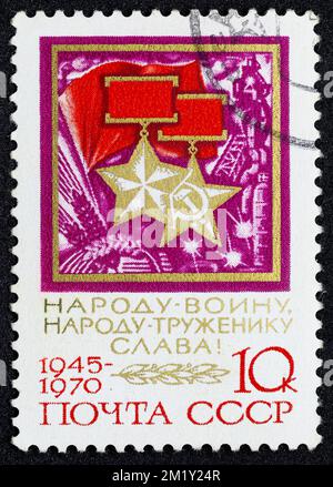 USSR - CIRCA 1970: Postage stamp 10 kopeck printed in the Soviet Union shows Gold Star of the Order of Hero and Medal of Socialist Labor. Post stamp s Stock Photo