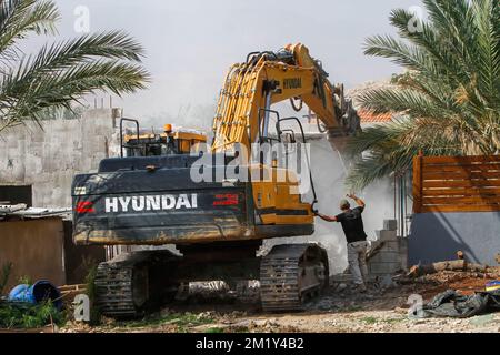 December 13, 2022, Jordan Valley, West bank, Palestine: Israeli army bulldozer on duty during the demolition of Palestinian homes in the northern Jordan Valley in the occupied West Bank. Israeli army bulldozer demolished Palestinian houses and homes to deport them from it because it's a border area between the land inhabited by Palestinians and the land was seized by the Israeli authorities. (Credit Image: © Nasser Ishtayeh/SOPA Images via ZUMA Press Wire) Stock Photo