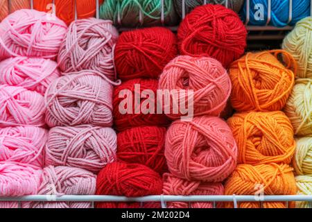 Fluffy skeins of colorful fluffy yarn , yarn for knitting, shelf in store. Sale of goods for creativity and needlework Stock Photo