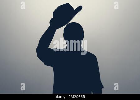 Silhouette of man waving his hat saying hello or welcome. Anonym club concept. Stock Photo