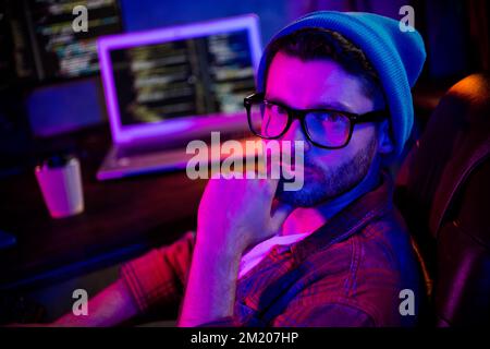 Photo of minded pensive coder dressed hat eyewear thinking new web safety progect indoors workplace workstation loft Stock Photo