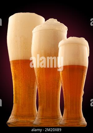 Set of beer into glass with foam and bubbles on a red background Stock Photo