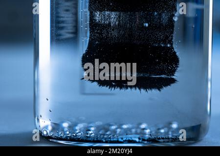 Iron nanoparticles in a lab, on a white glossy surface Stock Photo