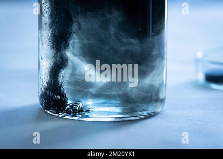 Iron nanoparticles in a lab, on a white glossy surface Stock Photo