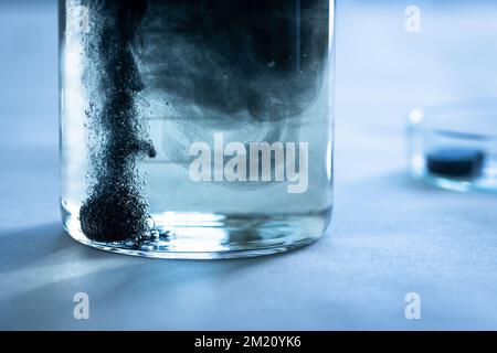Iron nanoparticles in a lab, on a white glossy surface Stock Photo