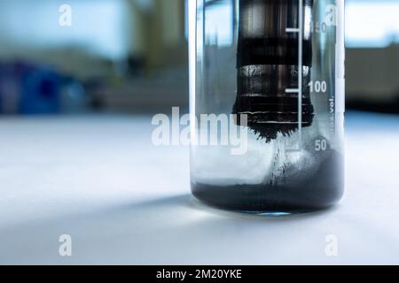 Iron nanoparticles in a lab, on a white glossy surface Stock Photo