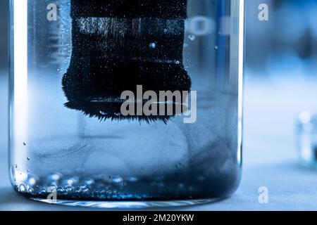Iron nanoparticles in a lab, on a white glossy surface Stock Photo