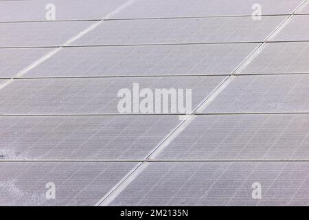 Individual solar panels of a photovoltaic system for power generation do not generate electricity due to frost and ice Stock Photo
