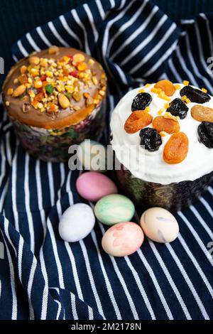 Easter eggs and Easter cakes lie on a striped blue apron. Easter religious holiday concept Stock Photo