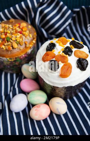 Easter eggs and Easter cakes lie on a striped blue apron. Easter religious holiday concept Stock Photo