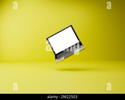 Laptop floating in the air on yellow background Stock Photo