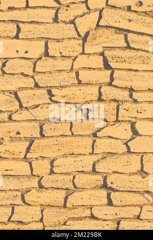 Sand color stone brick yellow vertical wall, modern texture ancient pattern background abstract. Stock Photo