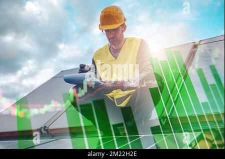 Man works on renewable energy system with solar panel for hot water Stock Photo