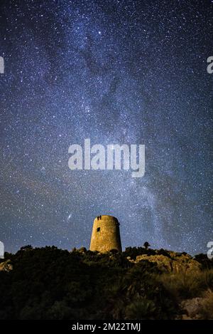 Night shot of milky way above the Albercutx watch tower, Alcudia, Mallorca, Spain Stock Photo